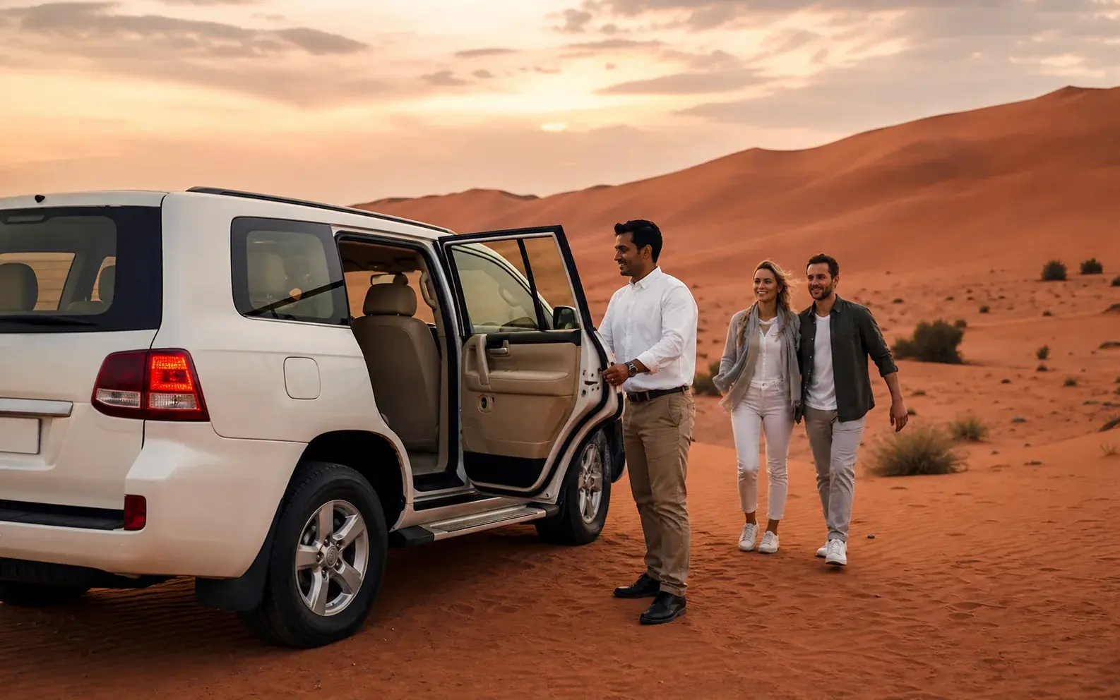 Safari guests walking back to their 4x4 after the Lahbab dune drive