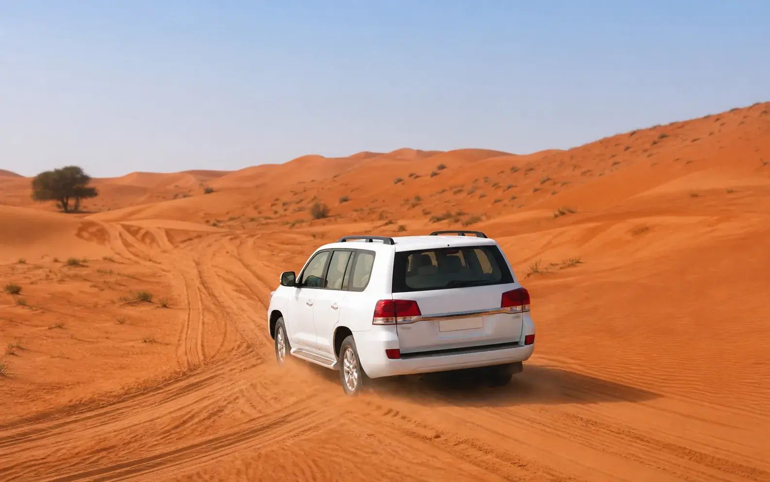 Safari 4x4 following a guided line across red dunes