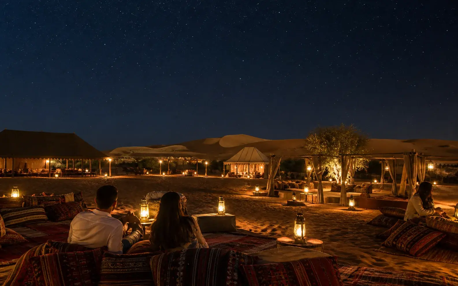 Quiet lantern-lit desert camp after the evening guests have left