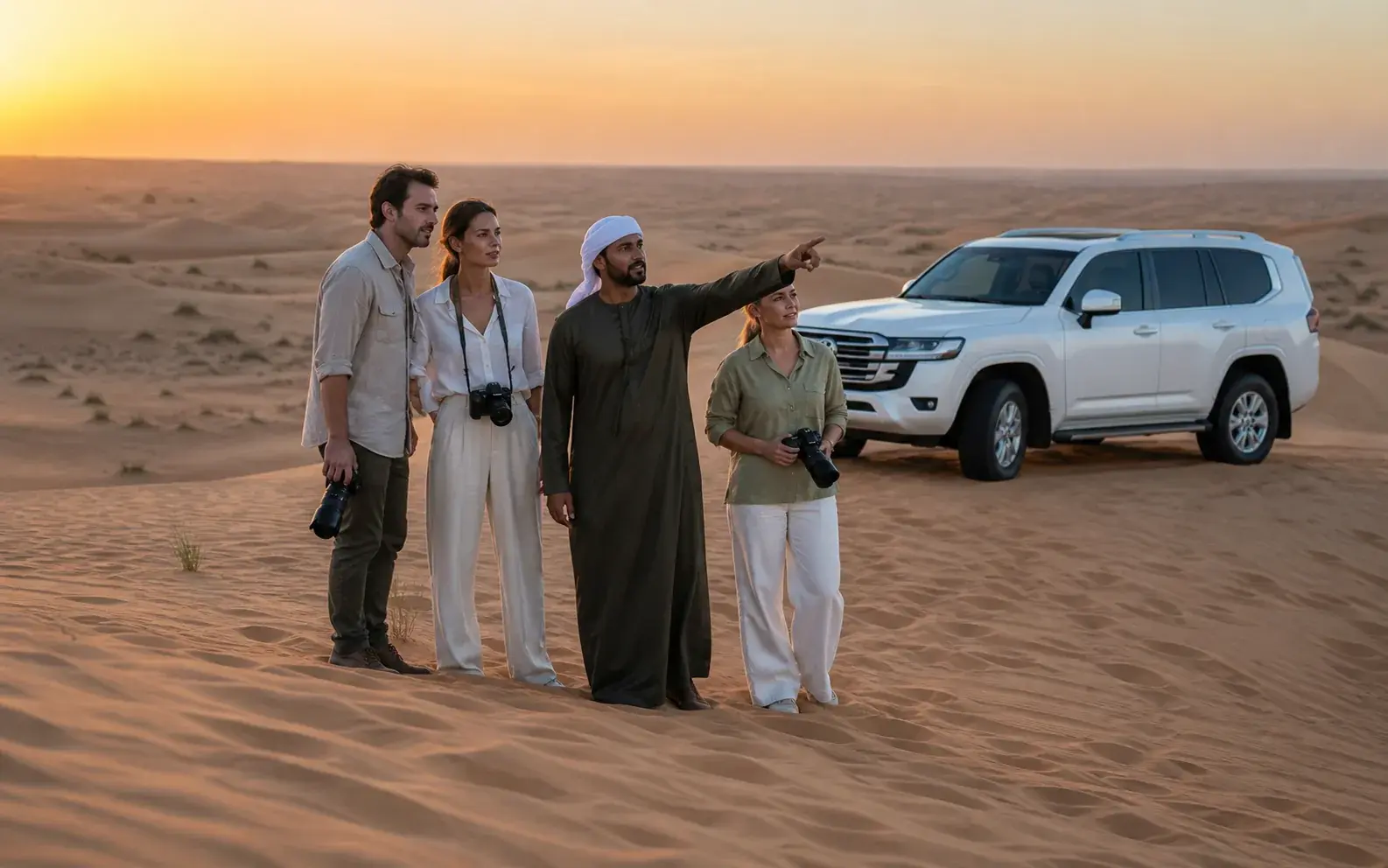 Family taking photos on a dune with their guide