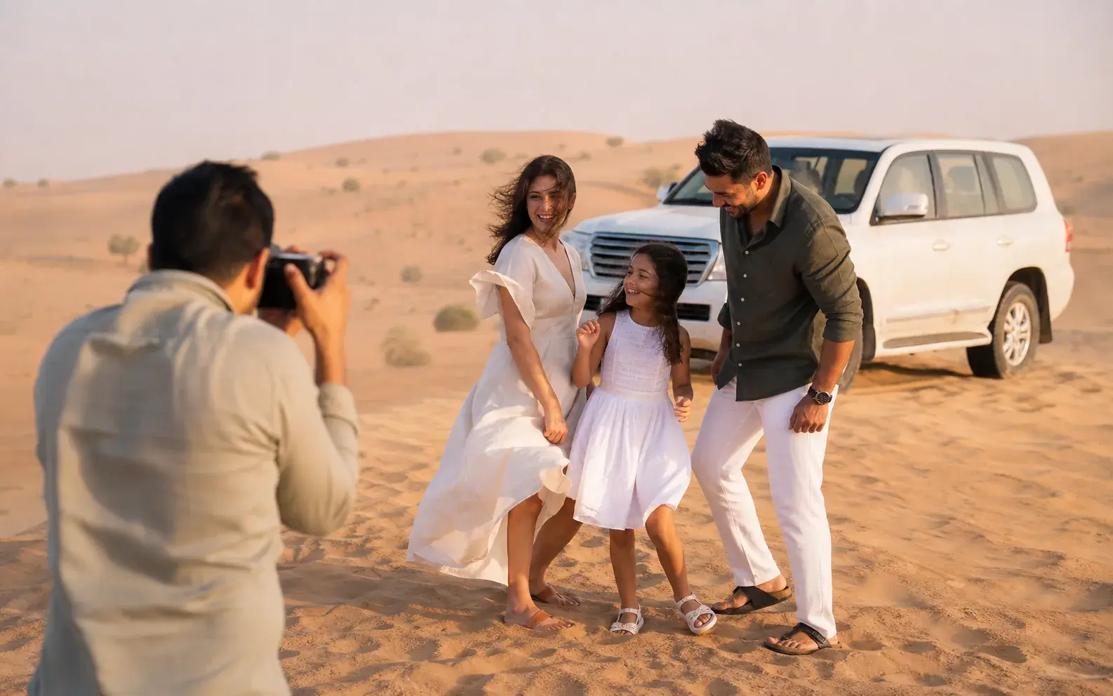 Private safari guide helping a family frame a photograph on the dunes