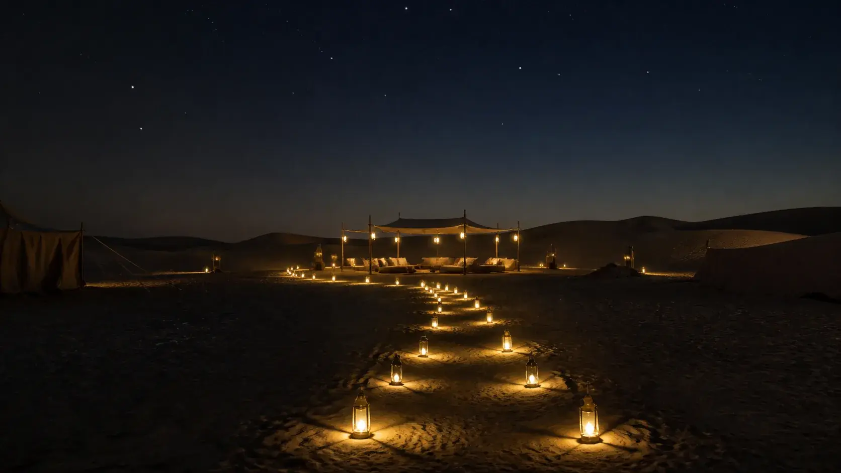 Lantern path leading to a quiet camp beneath the Dubai desert night sky