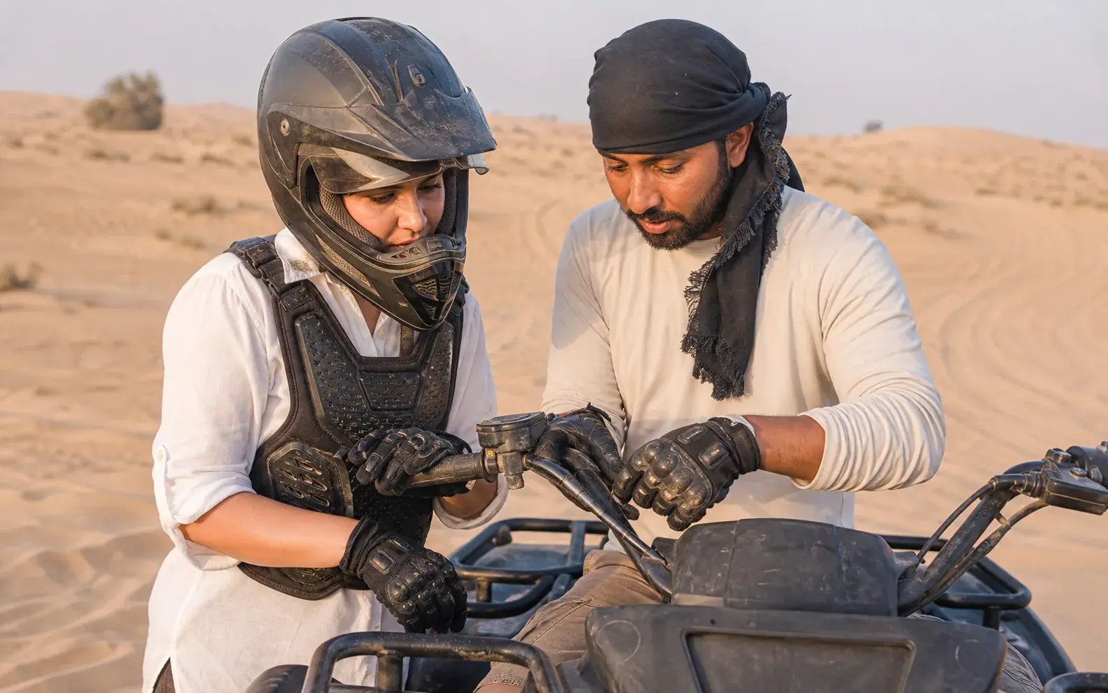 Gloved hands on quad-bike controls during a stationary safety check